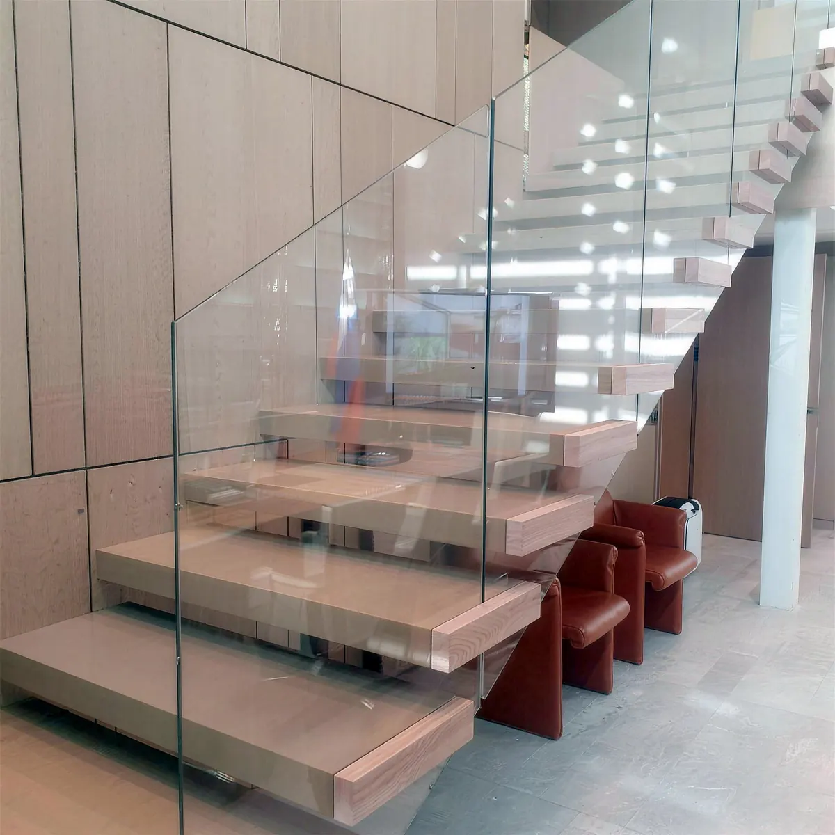 Floating oak stairs with a glass railing